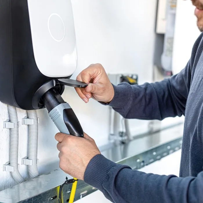 Electrician installing a residential EV charging station